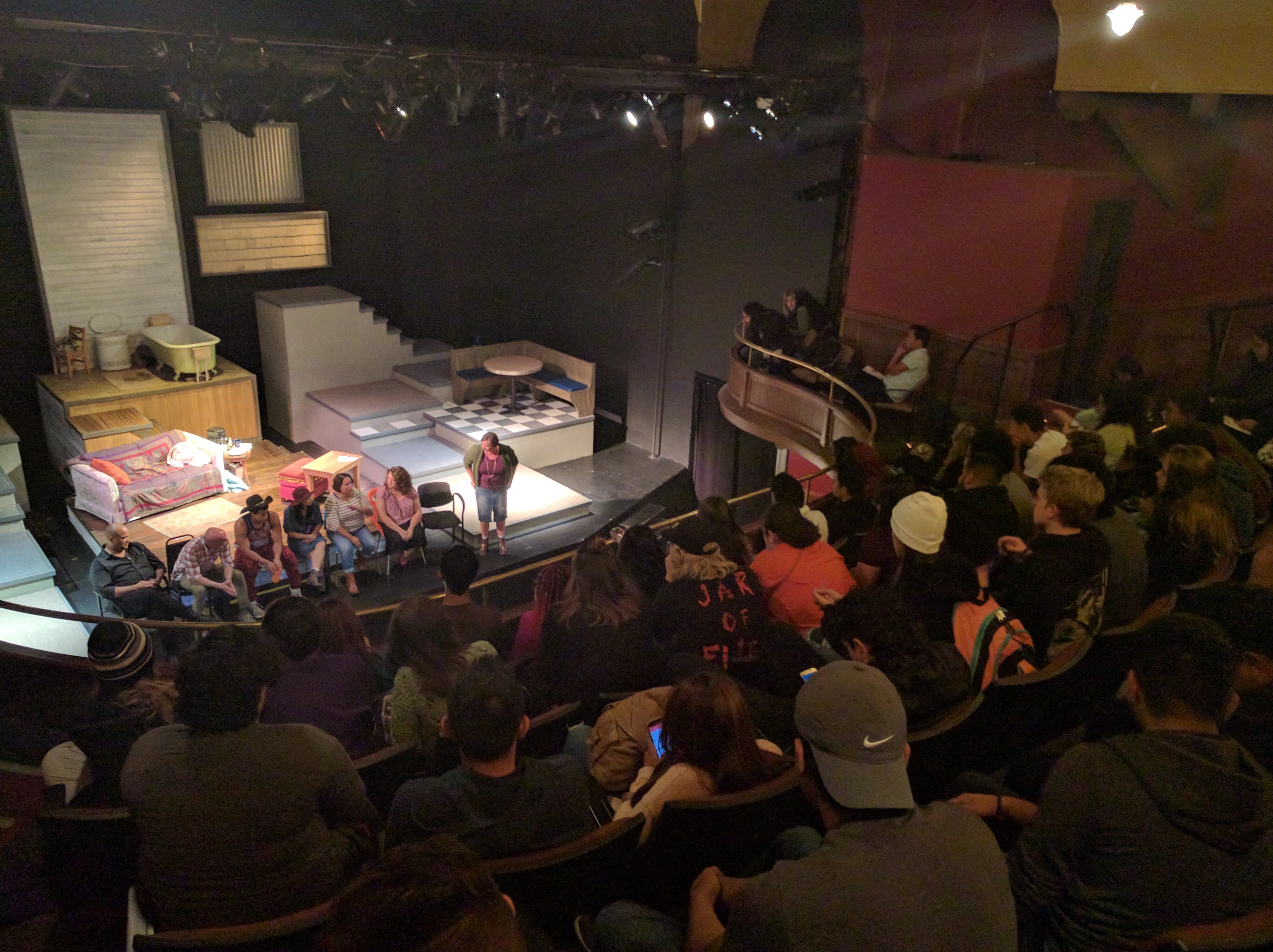 Students pack the seats at Curious Theatre and participate in a question and answer session with the cast of the play they are about to see.